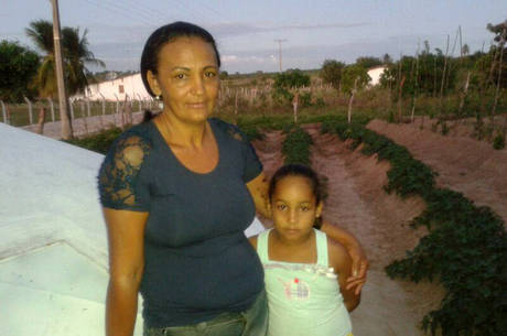 Maria Lúcia e a filha de Yasmin em frente à horta da família, em Santo Antônio (RN): "A gente andava quatro horas atrás de água"