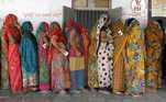 Mulheres fazem fila para votar na primeira fase das eleições em Sanand, no estado de Gujarat, na Índia. 