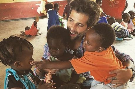Bruno recebendo abraço de crianças africanas