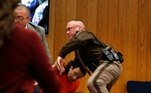 Randall Margraves (L) lunges at Larry Nassar (wearing orange) a former team USA Gymnastics doctor who pleaded guilty in November 2017 to sexual assault charges, during victim statements of his sentencing in the Eaton County Circuit Court in Charlotte, Michigan, U.S., February 2, 2018. REUTERS/Rebecca Cook TPX IMAGES OF THE DAY