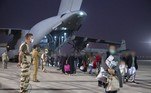 This handout photo taken and released by the French Etat-major des Armees on August 18, 2021 shows people getting off a French Air Force Airbus A400M at the air base of Al Dhafra, near Abu Dhabi after being evacuated from Kabul as part of the operation 'Apagan'. The military operation dubbed 'Apagan' was launched on August 15, 2021 in order to evacuate people from Afghanistan where the Taliban have taken over the country.
Handout / ETAT MAJOR DES ARMEES / AFP

