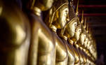 A row of Buddha statues is seen at the Wat Suthat Thepwararam temple in Bangkok on April 5, 2021.
Mladen ANTONOV / AFP
