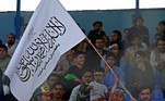 A child holds a Taliban flag as spectators watch the Twenty20 cricket trial match being played between two Afghan teams 'Peace Defenders' and 'Peace Heroes' at the Kabul International Cricket Stadium in Kabul on September 3, 2021.
Aamir QURESHI / AFP