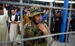 A Taliban fighter stands guard as spectators watch the Twenty20 cricket trial match being played between two Afghan teams 'Peace Defenders' and 'Peace Heroes' at the Kabul International Cricket Stadium in Kabul on September 3, 2021.
Aamir QURESHI / AFP