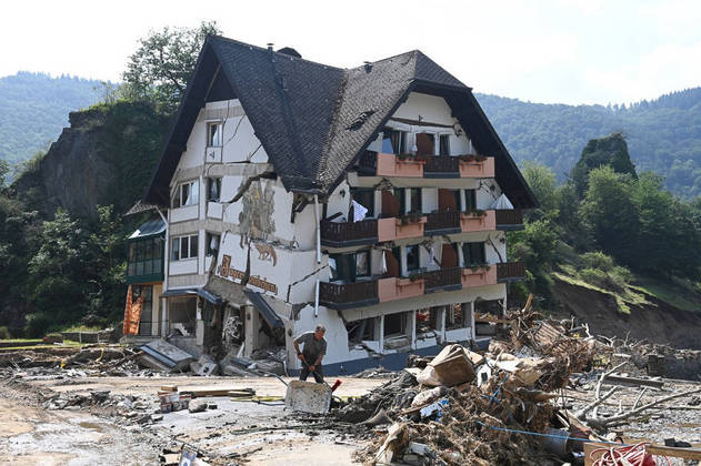 A worker is seen during clearing work in front of the destroyed building of the country guest house 'Jaegerstuebchen' in Laach, part of the municipality of Mayschoss, district of Ahrweiler, western Germany, on July 23, 2021, about a week after heavy rain and floods caused major damage in the Ahr region. In mid-July western Europe was hit by devastating floods after torrential rains that ravaged entire villages and left at least 209 people dead in Germany and Belgium, as well as dozens missing. The flooding also caused damage in Luxembourg, the Netherlands and Switzerland.
CHRISTOF STACHE / AFP
