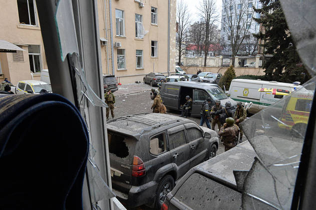 Ukrainian service members are seen outside the damaged local city hall of Kharkiv on March 1, 2022, destroyed as a result of Russian troop shelling. The central square of Ukraine's second city, Kharkiv, was shelled by advancing Russian forces who hit the building of the local administration, regional governor Oleg Sinegubov said. Kharkiv, a largely Russian-speaking city near the Russian border, has a population of around 1.4 million.
Sergey BOBOK / AFP