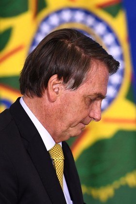 FILES) In this file photo taken on June 29, 2021 Brazilian President Jair Bolsonaro attends the launching ceremony of a new registry of professional fishermen, at Planalto Palace in Brasilia. The Brazilian Public Prosecutor's office announced on July 2, 2021 the "establishment of an investigation" after Bolsonaro was accused of not denouncing a corruption attempt in the purchase of vaccines against COVID-19. EVARISTO SA / AFP