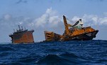 The fire stricken Singapore-registered container ship MV X-Press Pearl (L) is seen sinking while being towed away from the coast of Colombo on June 2, 2021 following Sri Lankan President Gotabaya Rajapaksa's order to move the ship to deeper water to prevent a bigger enviromental disaster.
ISHARA S. KODIKARA / AFP