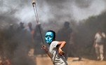 A Palestinian child uses a slingshot to hurl stones during clashes with Israeli forces in the village of Beita in the north of the occupied West Bank on July 30, 2021.
JAAFAR ASHTIYEH / AFP
