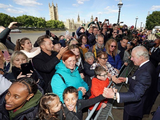 Britain's King Charles III talks with members of the public waiting in the queue to pay their respects to Queen Elizabeth II, Lying-in-State at the Palace of Westminster, on the South Bank in London on September 17, 2022. Queen Elizabeth II will lie in state in Westminster Hall inside the Palace of Westminster, until 0530 GMT on September 19, a few hours before her funeral, with huge queues expected to file past her coffin to pay their respects.
Aaron Chown / POOL / AFP
