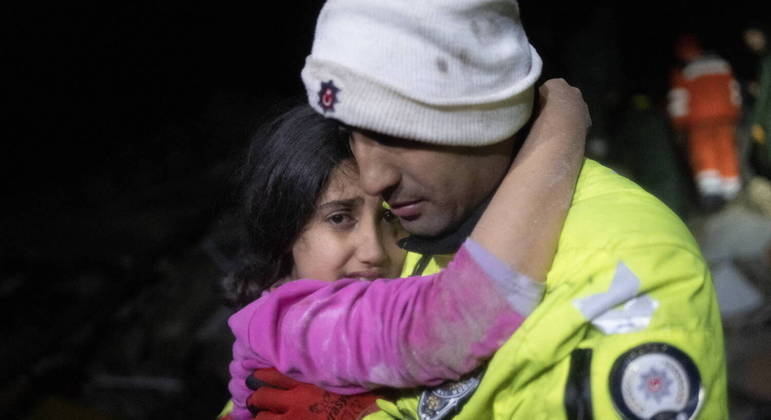 Police officer Zekeriya Yildiz hugs his daughter after they saved her from the rubble in Hatay on February 6, 2023, after a 7.8-magnitude earthquake struck the country's south-east. A major 7.8-magnitude earthquake struck Turkey and Syria, killing more than 3,000 people and flattening thousands of buildings as rescuers dug with bare hands for survivors.