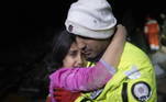 Police officer Zekeriya Yildiz hugs his daughter after they saved her from the rubble in Hatay on February 6, 2023, after a 7.8-magnitude earthquake struck the country's south-east. A major 7.8-magnitude earthquake struck Turkey and Syria, killing more than 3,000 people and flattening thousands of buildings as rescuers dug with bare hands for survivors.