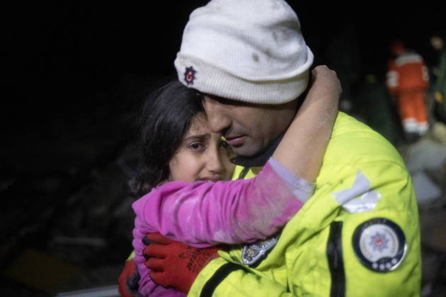 Police officer Zekeriya Yildiz hugs his daughter after they saved her from the rubble in Hatay on February 6, 2023, after a 7.8-magnitude earthquake struck the country's south-east. A major 7.8-magnitude earthquake struck Turkey and Syria, killing more than 3,000 people and flattening thousands of buildings as rescuers dug with bare hands for survivors.