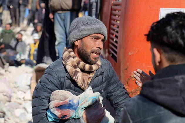 A man carries the body of his baby pulled out from the rubble in the town of Harim, in Syria's rebel-held noryhwestern Idlib province on the border with Turkey, on February 8, 2023, two days after a deadly earthquake that hit Turkey and Syria. The death toll from the massive earthquake that struck Turkey and Syria on February 6 rose above 8,300, official data showed, with rescue workers on February 8 still searching for trapped survivors.
Mohammed AL-RIFAI / AFP