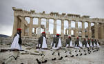 Members of the Presidential Guard walk in front of the Parthenon temple atop of Acropolis Hill before the Greek flag raising ceremony celebrating the 200th anniversary of 1821 revolution and war of independence, in Athens, on March 25, 2021.
Petros Giannakouris / POOL / AFP
