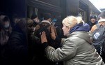 A woman says goodbye as a train with evacuees is about to leave Kyiv's railway station on March 2, 2022. Russia steps up its bombing campaign and missile strikes on Ukraine's cities on March 2, 2022.
Sergei CHUZAVKOV / AFP