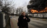 A woman reacts as she stands in front of a house burning after being shelled in the city of Irpin, outside Kyiv, on March 4, 2022. More than 1.2 million people have fled Ukraine into neighbouring countries since Russia launched its full-scale invasion on February 24, United Nations figures showed on March 4, 2022.
Aris Messinis / AFP