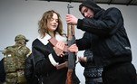 A woman learns how to use an AK-47 assault rifle during a civilians self-defence course in the outskirts of Lviv, western Ukraine, on March 4, 2022. The Russian army occupied on March 4, 2022 the Ukrainian nuclear power plant of Zaporozhie (south), the largest in Europe, where bombings in the night have raised fears of a disaster as more than 1.2 million people have fled Ukraine into neighbouring countries since Russia launched its full-scale invasion on February 24, United Nations figures showed on March 4, 2022.
Daniel LEAL / AFP