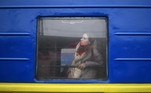 A woman, who arrives from Odessa, looks out from a carriage window at a train station in Lviv, western Ukraine, as she prepares to continue her journey to Slovakia on March 3, 2022. Russian forces have taken over the Ukrainian city of Kherson, local officials confirmed March 2, 2022 the first major urban centre to fall since Moscow invaded a week ago.
Daniel LEAL / AFP
