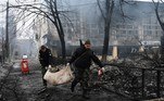 Police officers remove the body of a passerby killed in yesterday's airstrike that hit Kyiv's main television tower in Kyiv on March 2, 2022. An apparent Russian airstrike hit Kyiv's main television tower in the heart of the Ukrainian capital on March 1, 2022.