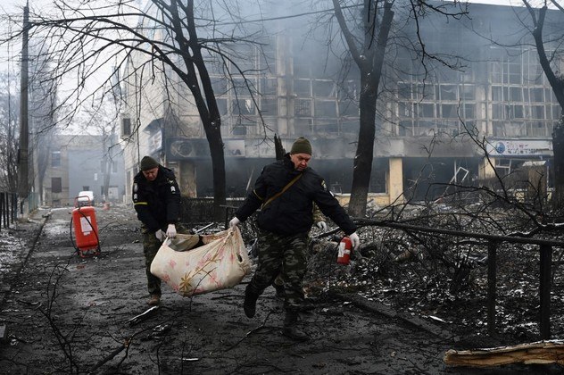 Police officers remove the body of a passerby killed in yesterday's airstrike that hit Kyiv's main television tower in Kyiv on March 2, 2022. An apparent Russian airstrike hit Kyiv's main television tower in the heart of the Ukrainian capital on March 1, 2022.