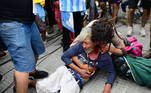 A Diego Maradona's fan cries after being injured during scuffles with the police while waiting to enter the Government House to pay tribute to late football legend Diego Armando Maradona in Buenos Aires, on November 26, 2020. Diego Maradona's coffin arrived at the presidential palace in Buenos Aires for a period of lying in state, TV reports showed, following the death of the Argentine football legend aged 60 on November 25. Hundreds of people were already lining up to pay their respects to Maradona, who died while recovering from a brain operation, the images from sports channels TyC and ESPN showed.
RONALDO SCHEMIDT / AFP
