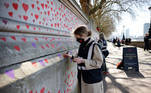 Red hearts are painted onto the wall of the embankment on the south side of the River Thames in memory of those who lost their lives to Covid-19 in London on March 29, 2021. A mural made up of almost 150,000 hand-drawn hearts is being painted to remember the victims of the coronavirus crisis.
Tolga Akmen / AFP