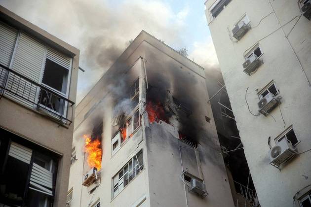Em Tel Aviv, a maior cidade do país, um prédio ficou em chamas após ter sido atingido por um míssil