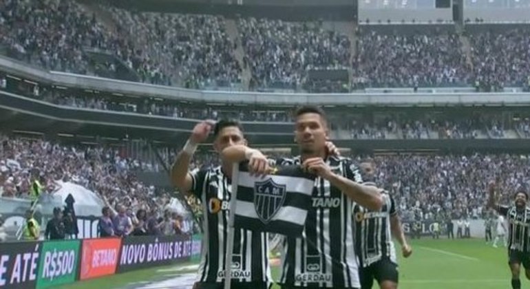 Paulinho posando, ao lado de Pavón, no primeiro gol da festa previsível contra o Santos
