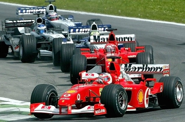 F1 - START:HKT02 - 20020512 - SPIELBERG, AUSTRIA : Ferrari driver Brazilian Rubens Barrichello (front) leads the pack into the first curve followed by his German teammate Michael Schumacher during the start of the Austrian Grand Prix in Spielberg, Sunday 12 May 2002. 
EPA PHOTO APA HANS KLAUS TECHT ht-hh