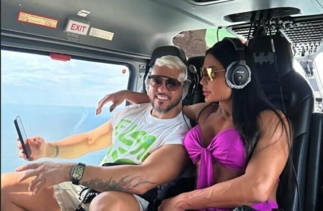 Belo e Gracyanne Barbosa: o cantor e a fisiculturista postaram foto nas redes sociais em helicóptero a caminho da embarcação. 