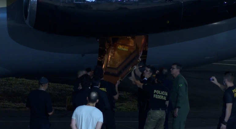 Caixão com os restos mortais encontrados no Amazonas é retirado de avião da PF em Brasília