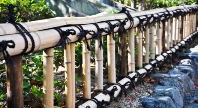 Cerca de bambu pequena amarrada com cordas em tom preto