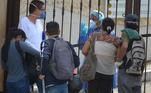 Familiares conversam com funcionários de cemitério em Guayaquil, Equador, que passa por colapso do sistema funerária por conta da pandemia de covid-19