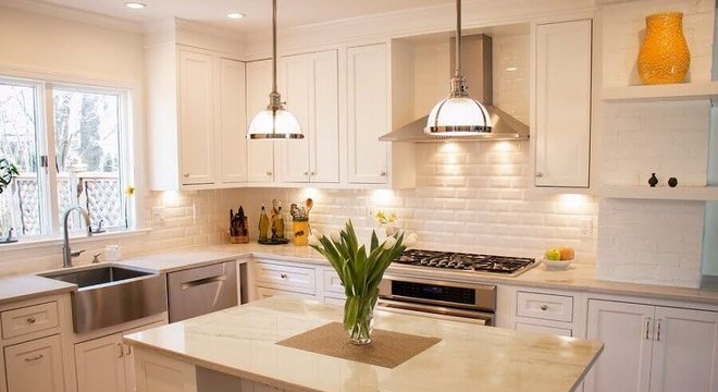 cozinha com ilha pequena e parede de tijolinho branco