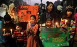 Students hold candles during a rally to pray for peace in year 2022 on New Year's Eve in Lahore, Pakistan, 31 December 2021. 