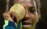 Rio De Janeiro (Brazil).- Rafaela Silva of Brazil poses with her gold medal after winning women's -57kg Final bout of the Rio 2016 Olympic Games Judo event in Rio de Janeiro, Brazil, 08 August 2016 (reissued 27 May 2020). Gold is considered a majestic color that symbolizes wealth and luxury. It is associated with success, achievement, and triumph, but it can also be deemed decadent and overindulgent. Connected with prestige and elegance, gold symbolizes divinity, power, and wisdom in many religions due to its association with masculine energy and the power of the sun. (Brasil) EFE/EPA/FACUNDO ARRIZABALAGA ATTENTION: This Image is part of a PHOTO SET *** Local Caption *** 52936752