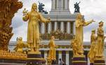 Moscow (Russian Federation).- Workers stand between the golden statues of the fountain 'Druzhba Narodov' (Friendship of Nations) in Moscow, Russia, 13 August 2019 (reissued 27 May 2020). Gold is considered a majestic color that symbolizes wealth and luxury. It is associated with success, achievement, and triumph, but it can also be deemed decadent and overindulgent. Connected with prestige and elegance, gold symbolizes divinity, power, and wisdom in many religions due to its association with masculine energy and the power of the sun. (Rusia, Moscú) EFE/EPA/SERGEI ILNITSKY ATTENTION: This Image is part of a PHOTO SET *** Local Caption *** 55393861