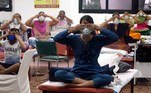 New Delhi (India), 30/07/2020.- Covid-19 infected patients perform yoga at the COVID 19 care center and isolation ward facility which is attached to a Hospital in New Delhi, India 30 July 2020. According to reports India is listed as the third country worldwide in regards to total COVID-19 cases after the United States and Brazil. (Brasil, Estados Unidos, Nueva Delhi) EFE/EPA/HARISH TYAGI