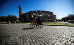 Rome (Italy), 15/03/2021.- A person runs in bike in front of the semi-desert Colosseum during the new lockdown for emergency of the Coronavirus Covid-19 pandemic in Rome, Italy, 15 March 2021. New restrictions came into effect from midnight 15 March as most of Italy will be a red zone in Italy's tier system due to a sharp rise in numbers of infections with the Sars-Cov-2 coronavirus that causes the Covid-19 disease. (Italia, Roma) EFE/EPA/ANGELO CARCONI