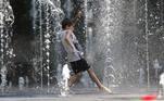Tbilisi (Georgia), 20/07/2020.- A child plays amid the jets of water gushing upward from a public fountain to cool off and mitigate the scorching midday heat in Tbilisi, Georgia, 20 July 2020. Temperatures reportedly reached up to 38 degrees Celsius (100.4 degrees Fahrenheit) in the Georgian capital. EFE/EPA/ZURAB KURTSIKIDZE