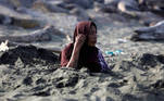 Banda Aceh (Indonesia), 26/02/2021.- Rumiati, 65, who suffered a stroke, sits in the sand receiving a traditional medical treatment with black sand at Syiah Kuala beach, Banda Aceh, Indonesia, 26 February 2021. Locals in the area believe that bathing with black sand can cure and prevent strokes and hypertension. EFE/EPA/HOTLI SIMANJUNTAK