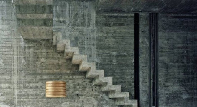 Escada flutuante de concreto fixada a uma parede de concreto