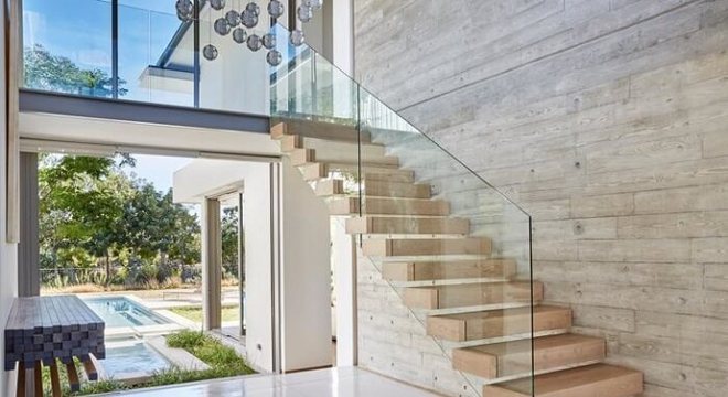 Escada flutuante de madeira com guarda-corpo de vidro temperado