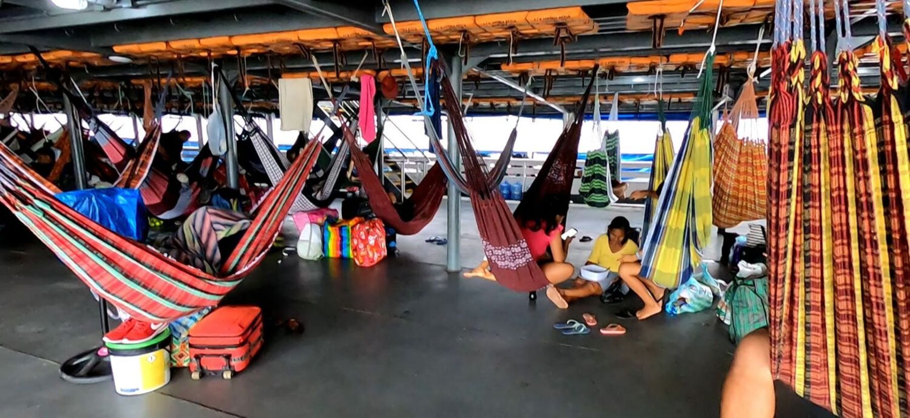 O barco fica cheio de redes espalhadas.
As pessoas se acomodam para enfrentar a viagem de horas pelos rios (Pedro Lopes/Record TV)