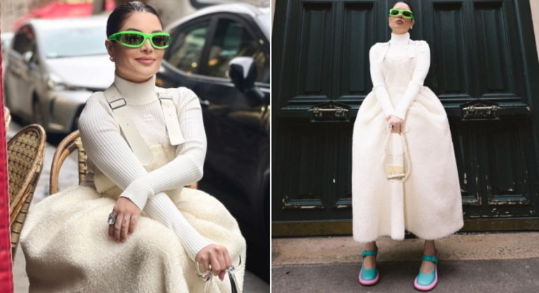 A influenciadora compartilhou diversos looks usados nesta última semana. Na foto, ela aparece com a já conhecida bolsa de vidro, da grife Coperni, que é avaliada em mais de R$ 13 mil. O vestido branco e felpudo é da Noir Kei Ninomiya, as sandálias, da JW Anderson, e os óculos, da Bottega Veneta. 