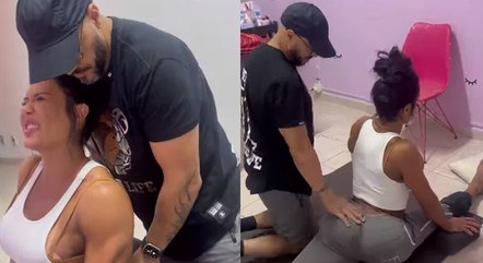 Gracyanne faz alongamento com a ajuda de Belo