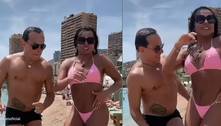 Gretchen e o marido exibem corpos sarados ao dançarem em dia de praia na Europa