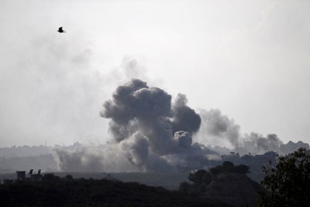 A picture taken from Sderot shows smoke plumes rising above buildings during an Israeli strike on the northern Gaza Strip on October 14, 2023. Hamas launched a large-scale attack on Israel on October 7 which killed at least 1300 people, sparking a retaliatory bombing campaign that has killed more than 1900 in the Gaza Strip ahead of a potential Israeli ground invasion of the territory.Aris MESSINIS / AFP