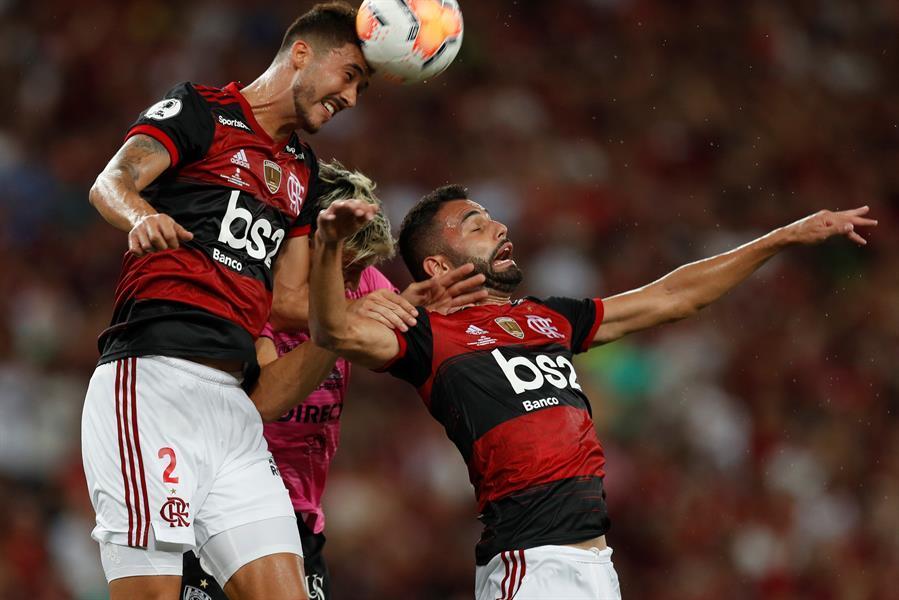 Gustavo Henrique of Brazil's Flamengo, top, heads the ball as